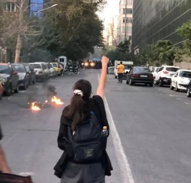 Image of a Young Girl Protesting in the Streets of Iran